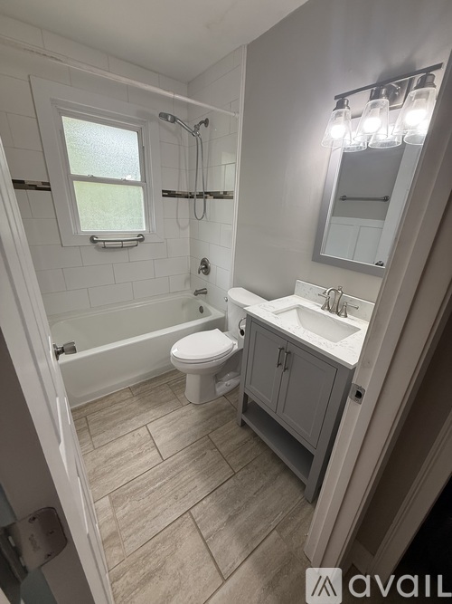 A bathroom with a toilet, sink, and tub.