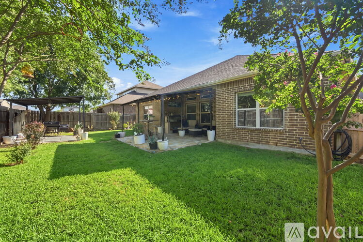 A house with a lawn and trees in front of it.