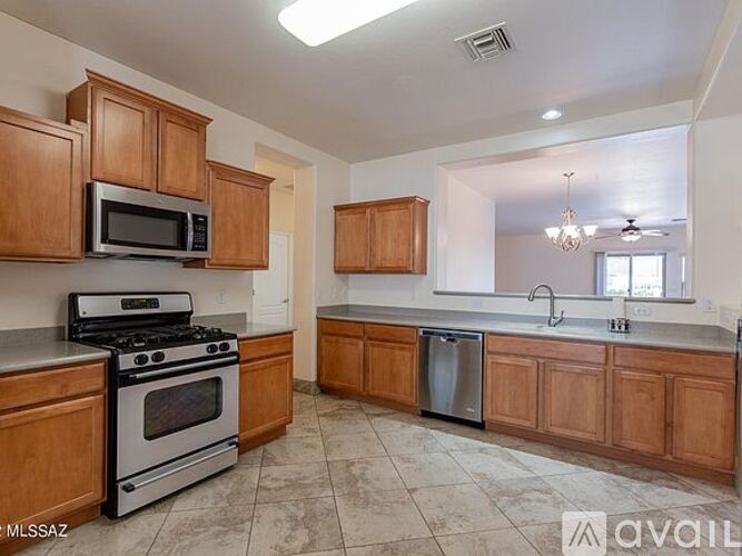 A kitchen with wooden cabinets and a stainless steel dishwasher.