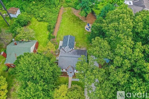 A bird's eye view of a house surrounded by trees.