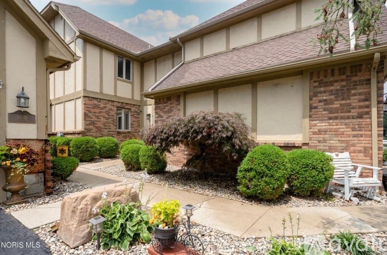 A house with a garden in front of it.