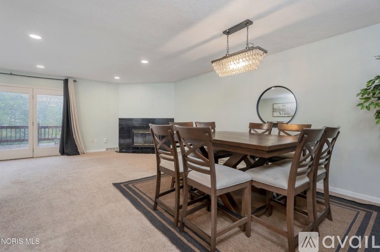 A dining room with a wooden table and chairs.