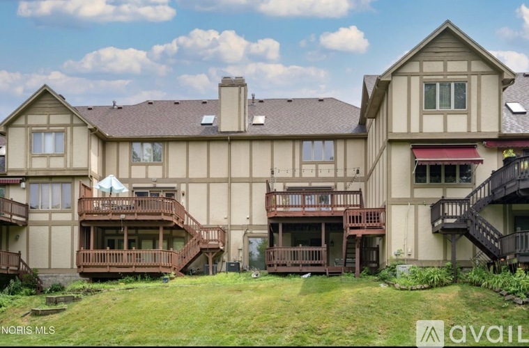 A large house with a balcony and a staircase leading to the second floor.
