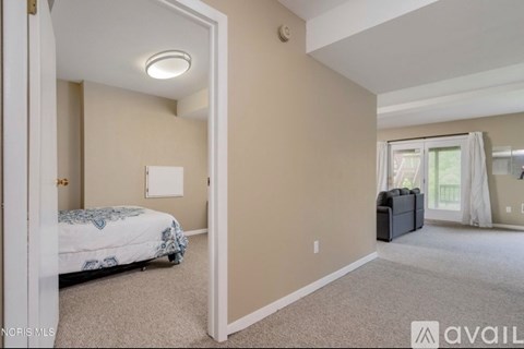 A bedroom with a bed, a dresser, and a window.