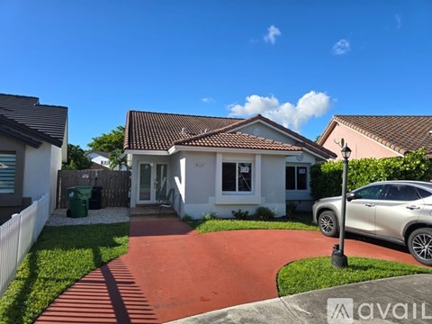 A house with a red pathway leading to the front door.