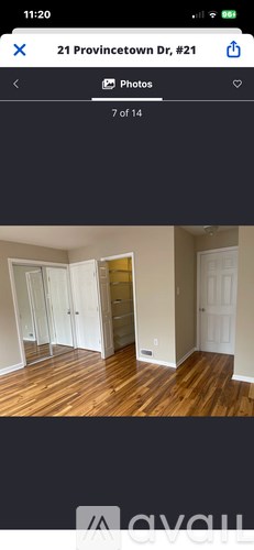 A room with wooden flooring and white walls.
