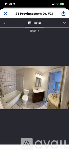 A bathroom with a bathtub, toilet, and sink.