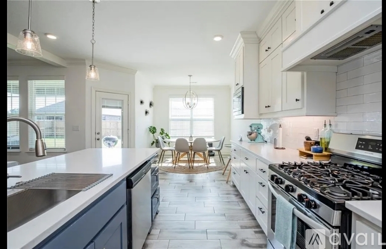 A modern kitchen with a dining area in the middle.