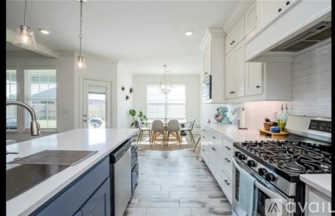 A modern kitchen with a dining area in the middle.