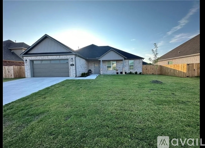 A house with a large lawn in front of it.