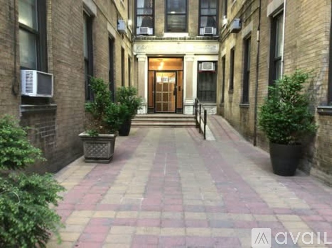 A brick building with a doorway and steps leading to it.