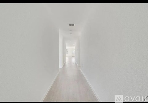 A long, narrow hallway with a light at the end.