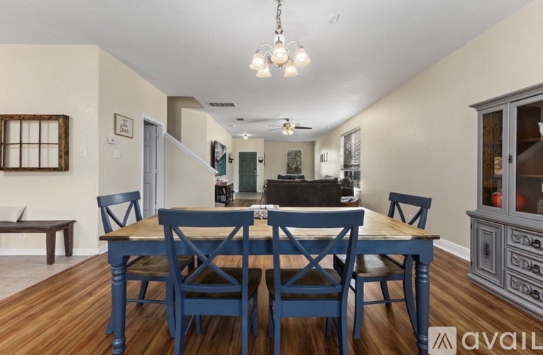 A dining room with a table set for six.