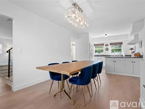 A dining room with a wooden table and blue chairs.