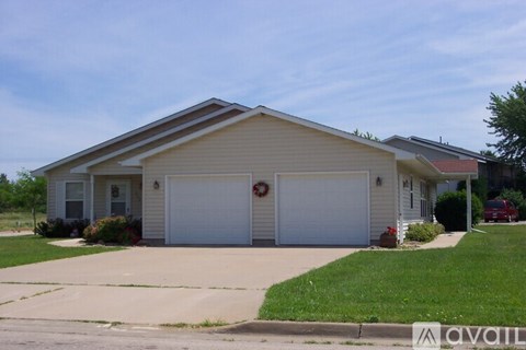 A two-car garage with a wreath on the door.