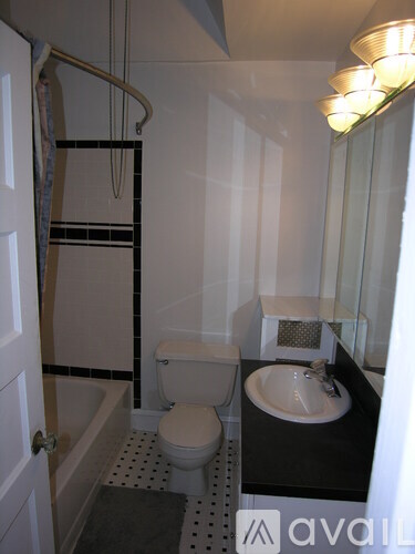 A bathroom with a toilet, sink, and bathtub.