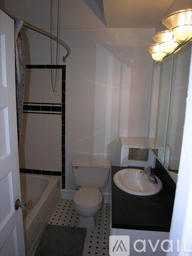 A bathroom with a toilet, sink, and bathtub.