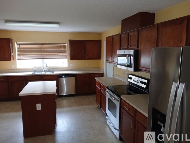 A kitchen with wooden cabinets and stainless steel appliances.