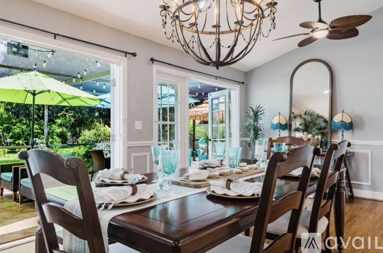 A dining room with a table set for a meal.