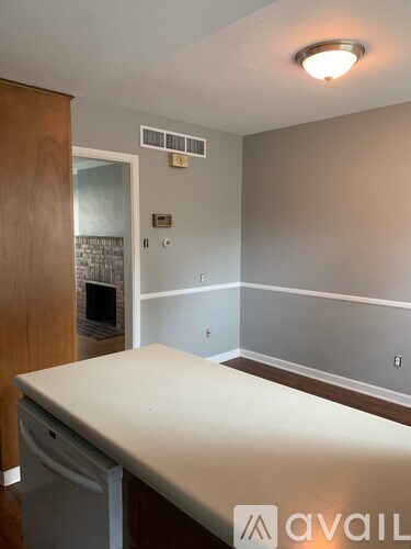 A room with a white table and a fireplace.