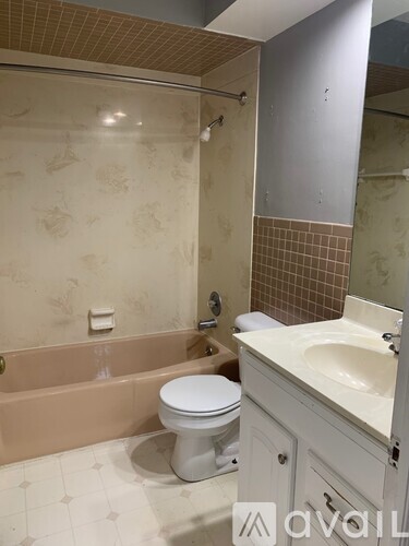 A bathroom with a toilet, sink, and bathtub.