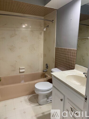 A bathroom with a toilet, sink, and bathtub.