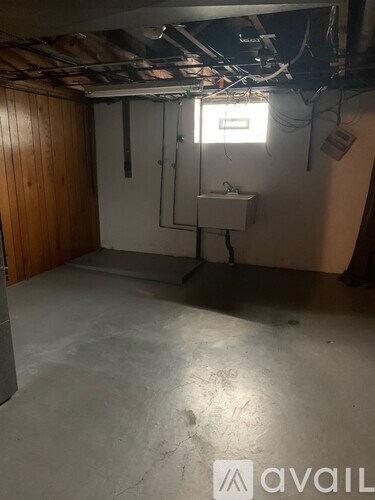 A room with a window and a sink in it.