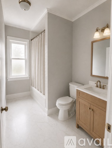 A bathroom with a toilet, sink, and mirror.