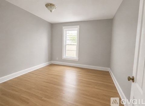 Empty room with wooden floor and white walls.