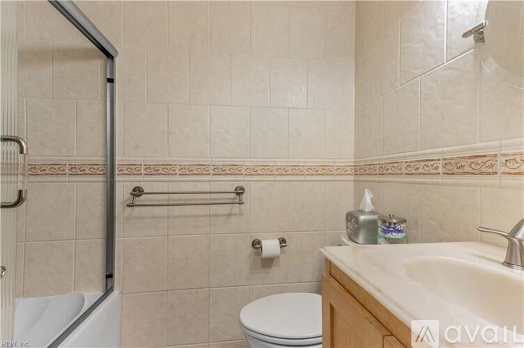 A bathroom with a toilet, sink, and shower.