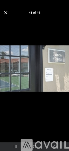 A sign on a wall that says "Fitness Center" is visible.