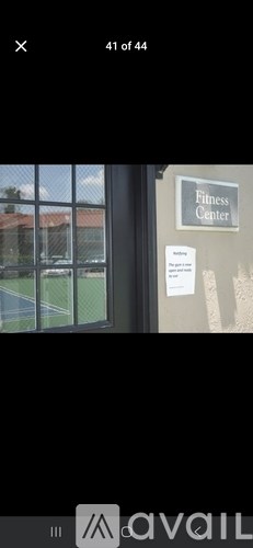 A sign on a wall that says "Fitness Center" is visible.