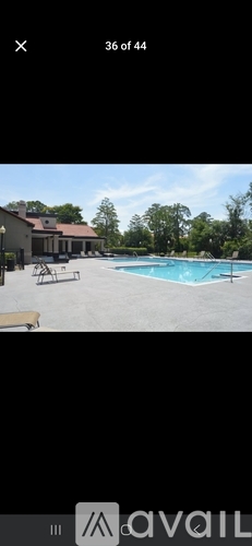 A pool with a house in the background.
