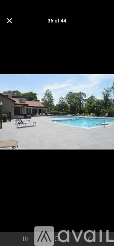 A pool with a house in the background.