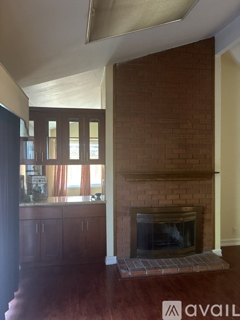 A room with a fireplace and wooden floors.