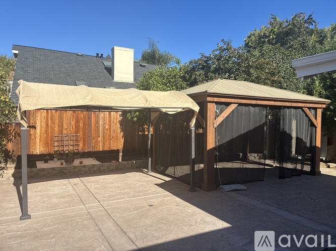 A wooden building with a covered patio area.