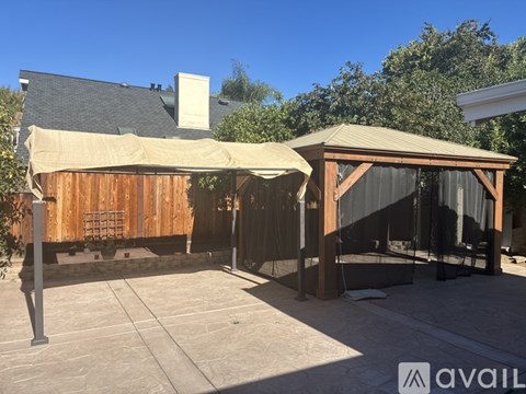 A wooden building with a covered patio area.