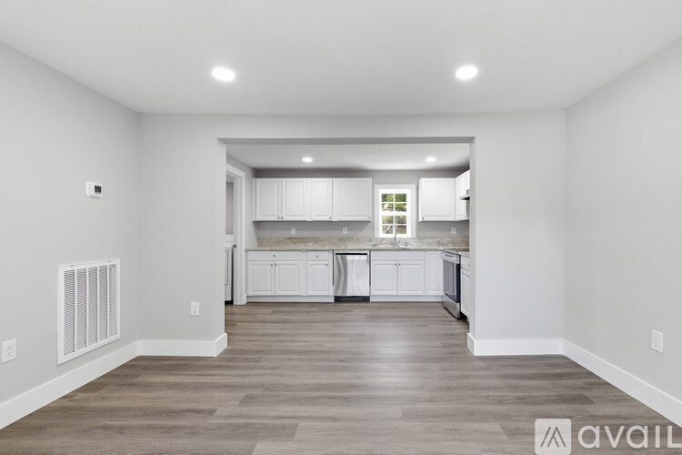 A spacious kitchen with white cabinets and a large island.