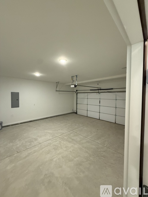 A spacious room with a tiled floor and a white wall.