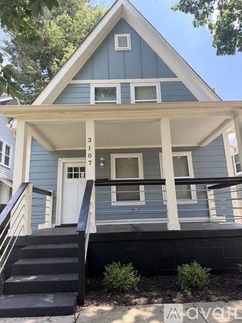 A blue house with white trim and a white door.