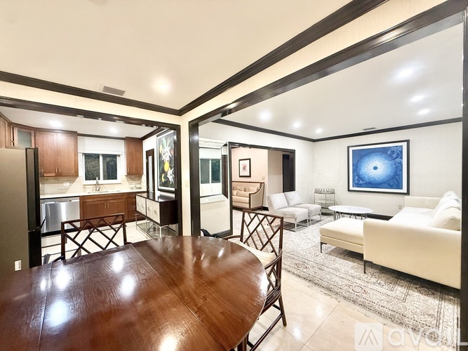 A modern living room with a wooden table and white couch.