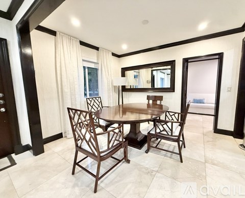 A dining room with a round table and chairs.