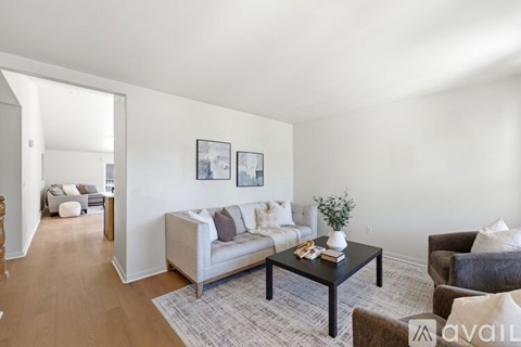 A living room with a white couch and a coffee table.