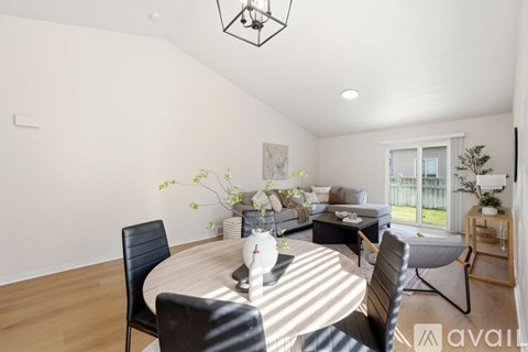 A modern dining room with a round table and chairs.