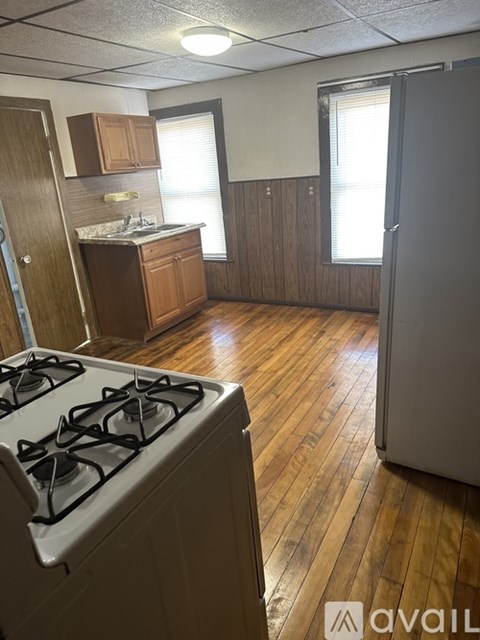 A kitchen with a stove and a refrigerator.