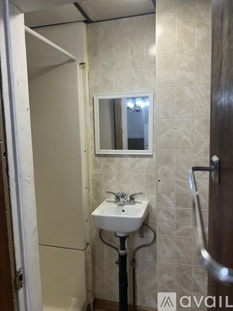 A bathroom with a sink and mirror.