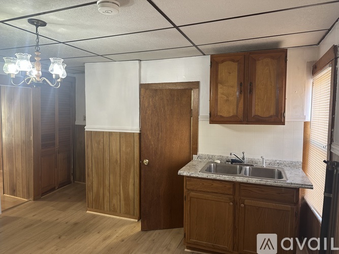 A kitchen with wooden cabinets and a sink.