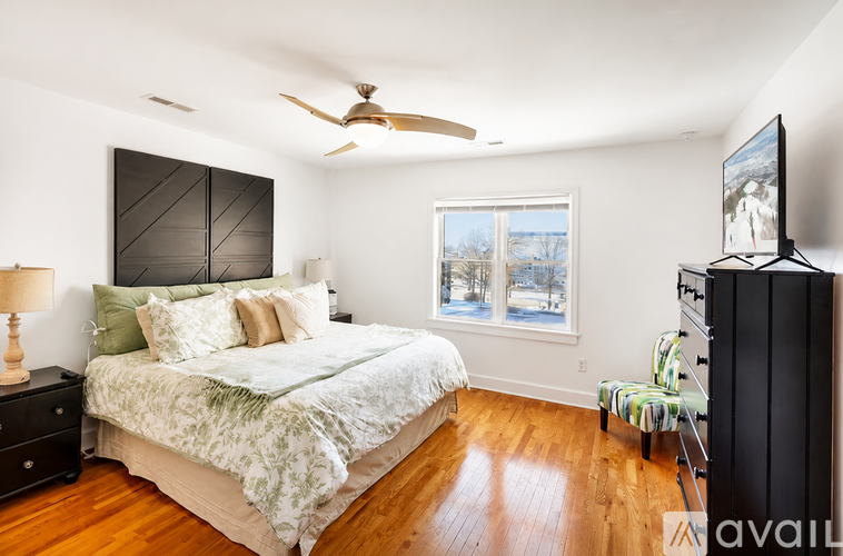 A bedroom with a large bed and a flat screen TV.