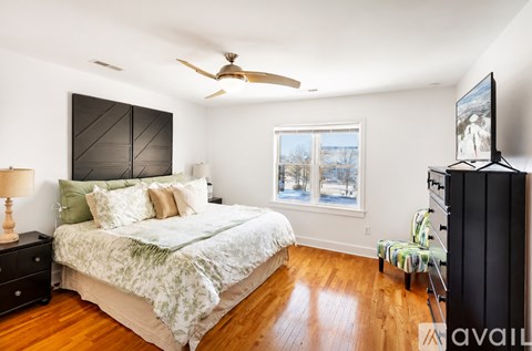 A bedroom with a large bed and a flat screen TV.