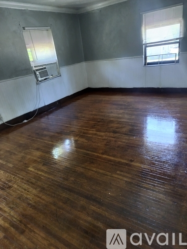 A room with wooden floors and a window.
